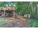 Large backyard featuring a deck, storage shed, and wooded privacy, perfect for outdoor activities at 4825 Whispering Pine Way, Cumming, GA 30028