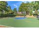 Community basketball court surrounded by lush landscaping perfect for recreational games and exercise at 4825 Whispering Pine Way, Cumming, GA 30028