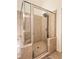 Bathroom featuring a tile surround, glass shower and tiled floor at 4825 Whispering Pine Way, Cumming, GA 30028