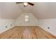 Bonus room featuring hardwood floors, vaulted ceiling, and natural light at 4825 Whispering Pine Way, Cumming, GA 30028