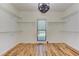 Spacious walk-in closet with hardwood floor, recessed lighting and window at 4825 Whispering Pine Way, Cumming, GA 30028