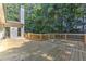Large wooden deck perfect for entertaining, surrounded by mature trees at 4825 Whispering Pine Way, Cumming, GA 30028