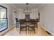 Bright dining room featuring a modern light fixture and hardwood floors at 4825 Whispering Pine Way, Cumming, GA 30028