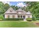 Charming home with well-manicured lawn surrounded by beautiful trees providing ample shade at 4825 Whispering Pine Way, Cumming, GA 30028