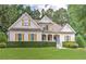 Charming two-story home with well-manicured lawn, beautiful shutters, and welcoming front porch at 4825 Whispering Pine Way, Cumming, GA 30028