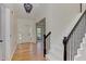 Bright foyer featuring hardwood floors, staircase with black iron railings, and contemporary lighting at 4825 Whispering Pine Way, Cumming, GA 30028