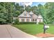Inviting home featuring a long drive way and meticulously maintained lawn and garden at 4825 Whispering Pine Way, Cumming, GA 30028