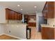 Kitchen with granite countertop and wood cabinets at 4825 Whispering Pine Way, Cumming, GA 30028