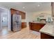 Spacious kitchen with stainless steel fridge, wooden cabinets, and granite countertops at 4825 Whispering Pine Way, Cumming, GA 30028