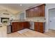 Open kitchen with wood cabinets, granite counters, and stainless steel dishwasher at 4825 Whispering Pine Way, Cumming, GA 30028