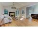 Spacious living room with fireplace, hardwood floors, and natural light at 4825 Whispering Pine Way, Cumming, GA 30028
