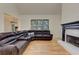 Spacious living room featuring a fireplace and large leather couch at 4825 Whispering Pine Way, Cumming, GA 30028