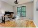 Well-lit office with hardwood floors, large window, and modern desk setup at 4825 Whispering Pine Way, Cumming, GA 30028