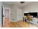 Bright home office boasts hardwood floors, a modern desk, and ample natural light at 4825 Whispering Pine Way, Cumming, GA 30028