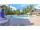 Community pool featuring ample seating and umbrellas perfect for relaxing by the water at 4825 Whispering Pine Way, Cumming, GA 30028