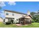 Backyard featuring a screened-in porch, patio, well-manicured lawn and mature trees at 11961 Markham Way, Hampton, GA 30228