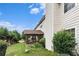 Well-maintained backyard with a covered porch, lush green grass, and mature landscaping at 11961 Markham Way, Hampton, GA 30228