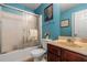 Bathroom featuring blue walls, sliding glass shower doors, and a dark wood vanity at 11961 Markham Way, Hampton, GA 30228