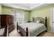 Cozy bedroom with a tray ceiling, traditional furniture, and a queen-sized bed at 11961 Markham Way, Hampton, GA 30228