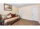 Bedroom with wood-look flooring, neutral walls, and a daybed with decorative pillows at 11961 Markham Way, Hampton, GA 30228