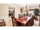 Formal dining room showcasing an elegant chandelier and a long, ornate table at 11961 Markham Way, Hampton, GA 30228