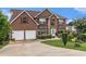 Well-maintained brick home with a two-car garage and an inviting, spacious driveway at 11961 Markham Way, Hampton, GA 30228