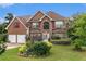 Attractive brick home boasting a beautifully landscaped front yard and red window shutters at 11961 Markham Way, Hampton, GA 30228
