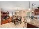 Open kitchen with granite countertops and stainless steel appliances that looks into the living room at 11961 Markham Way, Hampton, GA 30228