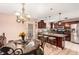 Eat-in kitchen with granite countertops, stainless steel appliances, and a breakfast nook with decorative chairs at 11961 Markham Way, Hampton, GA 30228