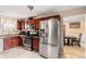 Well-lit kitchen with stainless steel appliances, including a large refrigerator and ample cabinet space at 11961 Markham Way, Hampton, GA 30228