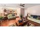 Open-concept living room with hardwood floors, cozy sofas, and backyard views at 11961 Markham Way, Hampton, GA 30228