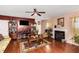 Comfortable living room featuring hardwood floors, a fireplace, and ample natural light at 11961 Markham Way, Hampton, GA 30228