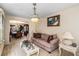 Bright living room showcasing a chandelier, plush sofa, and elegant decor at 11961 Markham Way, Hampton, GA 30228