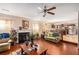 Warm living area with fireplace, open to the kitchen, and featuring hardwood floors at 11961 Markham Way, Hampton, GA 30228