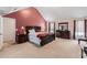 Spacious main bedroom featuring a vaulted ceiling, large bed, and ample natural light from multiple windows at 11961 Markham Way, Hampton, GA 30228