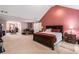 Large main bedroom with a seating area, featuring a vaulted ceiling, large bed, and ample natural light at 11961 Markham Way, Hampton, GA 30228