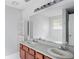 Bright bathroom features a double sink vanity, large mirror and a view of the tub at 1553 Smithson Ct, Lithonia, GA 30058