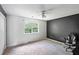 Spacious bedroom featuring a ceiling fan and a large window offering natural light at 1553 Smithson Ct, Lithonia, GA 30058