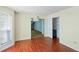The dining room features hardwood floors, a modern chandelier, and natural light from the window at 1553 Smithson Ct, Lithonia, GA 30058