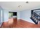 Spacious living room with hardwood floors, open staircase, and large windows at 1553 Smithson Ct, Lithonia, GA 30058