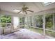 Bright sunroom with large windows and tile floor, offering views of the wooded surroundings at 1553 Smithson Ct, Lithonia, GA 30058