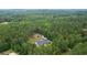 An aerial view of the home features a pool, a large lot, and a separate garage surrounded by mature trees at 188 A Macedonia Rd, White, GA 30184