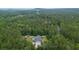 Aerial view of house, yard, and shed with pool in a wooded area at 188 A Macedonia Rd, White, GA 30184