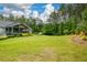 Spacious backyard with a covered patio, a charming greenhouse, and mature trees at 188 A Macedonia Rd, White, GA 30184