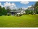 Expansive backyard featuring a well-maintained lawn, screened porch, and a greenhouse, perfect for gardening at 188 A Macedonia Rd, White, GA 30184