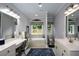 This bathroom features a long vanity, an enclosed tub, and a window with a view at 188 A Macedonia Rd, White, GA 30184