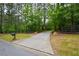 Long, paved driveway leading to a secluded home nestled in a serene, wooded setting at 188 A Macedonia Rd, White, GA 30184