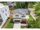 Aerial view of a modern home featuring a well-manicured lawn, dark roof, and a two-car garage at 3155 Zion St, Scottdale, GA 30079