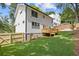 Well-manicured lawn with a wooden fence surrounding the home, and a wooden deck at 3155 Zion St, Scottdale, GA 30079