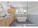 Modern bathroom featuring a soaking tub, double vanity, and glass-enclosed shower at 3155 Zion St, Scottdale, GA 30079